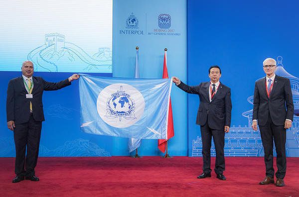 In this photo provided by Interpol, a Palestinian delegate receives the INTERPOL flag from the president of the International Criminal Police Organization Meng Hongwei second right, during the Interpol General Assembly, in Beijing, China, Wednesday, Sept. 27, 2017 - Sputnik International