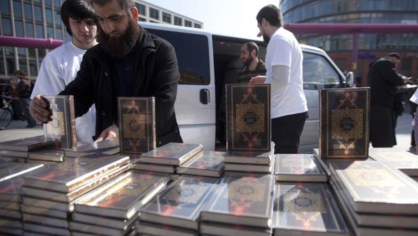 Members of a Muslim group pile Qurans while distributing copies of it at Potsdamer Platz in Berlin. (File) Members of a Muslim group pile Qurans while distributing copies of it at Potsdamer Platz in Berlin. (File) - Sputnik International