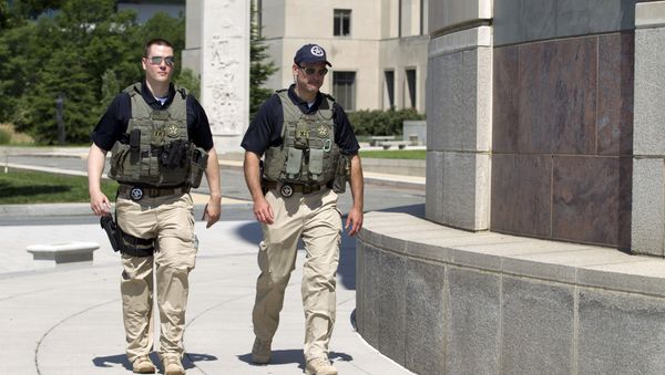 US Marshalls move outside the federal US District Court in Washington Saturday, June 28, 2014, after security was heightened in anticipation of a possible court appearance by captured Libyan militant Ahmed Abu Khattala later in the day. - Sputnik International