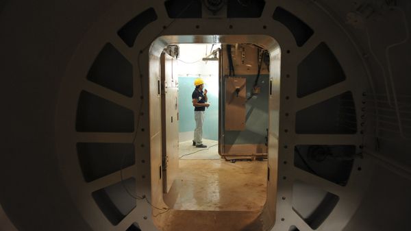 A worker stands at the entrance of the reactor of Bushehr nuclear power plant, outside the southern city of Bushehr, Iran (File) - Sputnik International