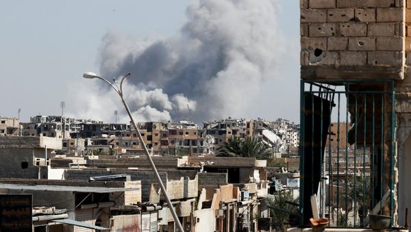 Smoke rises near the stadium where the Islamic State militants are holed up after an air strike by coalition forces at the frontline, in Raqqa, Syria October 12, 2017 - Sputnik International
