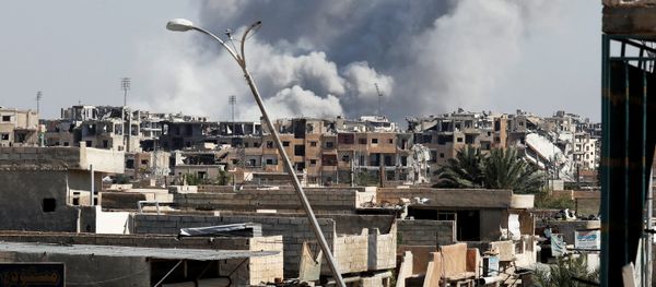 Smoke rises near the stadium where the Islamic State militants are holed up after an air strike by coalition forces at the frontline, in Raqqa, Syria October 12, 2017 Smoke rises near the stadium where the Islamic State militants are holed up after an air strike by coalition forces at the frontline, in Raqqa, Syria October 12, 2017 - Sputnik International