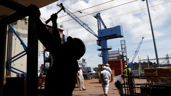A worker uses a hammer at the exit of the hanger of HMS Queen Elizabeth, the first of two aircraft carriers being built by British defence firm BAE Systems, at the Rosyth Dockyard in Fife, Scotland June 17, 2014 A worker uses a hammer at the exit of the hanger of HMS Queen Elizabeth, the first of two aircraft carriers being built by British defence firm BAE Systems, at the Rosyth Dockyard in Fife, Scotland June 17, 2014 - Sputnik International