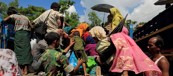 A military member helps a Rohingya refugee boy who arrived from Myanmar to get onto a truck that will take him to a refugee camp from a relief centre in Teknaf, near Cox's Bazar in Bangladesh, October 13, 2017 A military member helps a Rohingya refugee boy who arrived from Myanmar to get onto a truck that will take him to a refugee camp from a relief centre in Teknaf, near Cox's Bazar in Bangladesh, October 13, 2017 - Sputnik International