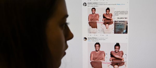 (FILES) This file photo taken on October 09, 2017 shows a posed photograph of a journalist looking at screenshots retweeted by Twitter users on the social networking site of a video-clip used in an online advert by the personal care brand Dove (FILES) This file photo taken on October 09, 2017 shows a posed photograph of a journalist looking at screenshots retweeted by Twitter users on the social networking site of a video-clip used in an online advert by the personal care brand Dove - Sputnik International