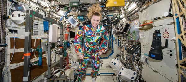This undated handout photo from NASA shows astronaut Kate Rubins aboard the International Space Station wearing a hand-painted spacesuit decorated by childhood cancer patients at the University of Texas MD Anderson Cancer Center in Houston. NASA said Rubins will chat from the space station with patients during a 20-minute call on Friday, Sept. 16, 2016 - Sputnik International