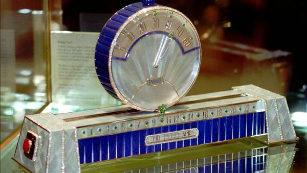 Swiss watch manufacture Piaget with the only model of the Sliding Clock at the 1998 International Fine Watchmaking Exhibition at Geneva, Switzerland. The hours are shown at the base of the clock and the minutes are shown on the disc sliding above the base. The price of these clock, with 926 diamonds (53,27 cts), 50 emeralds (11.63 cts), two rubies, gold weight 930 grams, is some $1.572 million. - Sputnik International