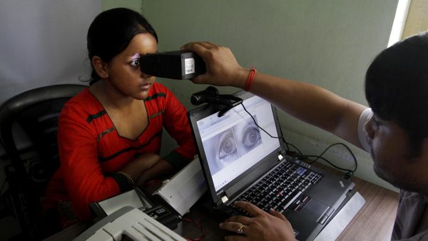 An Indian girl, left, gets her retina scanned as she enrolls for Aadhar, India’s unique identification project in Kolkata, India, Wednesday, May 16, 2012 An Indian girl, left, gets her retina scanned as she enrolls for Aadhar, India’s unique identification project in Kolkata, India, Wednesday, May 16, 2012 - Sputnik International