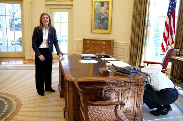 President Barack Obama examines the Resolute desk on March 3, 2009, while visiting with Caroline Kennedy Schlossberg in the Oval Office. A device with a little red button can be seen next to the telephone. - Sputnik International