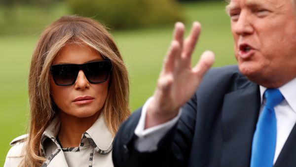 First Lady Melania Trump looks on as US President Donald Trump speaks to reporters upon his departure from the White House in Washington, US, October 13, 2017. - Sputnik International
