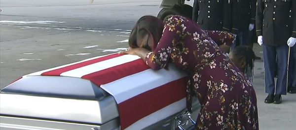 In this Tuesday, Oct. 17, 2017, frame from video, Myeshia Johnson cries over the casket of her husband, Sgt. La David Johnson, who was killed in an ambush in Niger, upon his body's arrival in Miami In this Tuesday, Oct. 17, 2017, frame from video, Myeshia Johnson cries over the casket of her husband, Sgt. La David Johnson, who was killed in an ambush in Niger, upon his body's arrival in Miami - Sputnik International