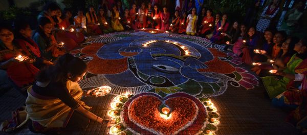 Students pose after lighting oil lamps around a Rangoli, a traditional pattern made from coloured powders and flower petals outside their hostel to celebrate Diwali, the Hindu festival of lights, in Guwahati, India, October 19, 2017 Students pose after lighting oil lamps around a Rangoli, a traditional pattern made from coloured powders and flower petals outside their hostel to celebrate Diwali, the Hindu festival of lights, in Guwahati, India, October 19, 2017 - Sputnik International