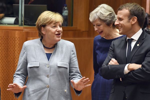 German Chancellor Angela Merkel, left, speaks with British Prime Minister Theresa May, center, and French President Emmanuel Macron prior to a round table meeting at an EU summit in Brussels on Thursday, Oct. 19, 2017. German Chancellor Angela Merkel, left, speaks with British Prime Minister Theresa May, center, and French President Emmanuel Macron prior to a round table meeting at an EU summit in Brussels on Thursday, Oct. 19, 2017. - Sputnik International