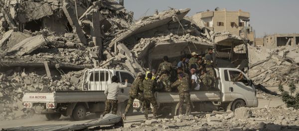 Members of the U.S.-backed Syrian Democratic Forces (SDF) ride near near the main traffic circle in Raqqa Syria, Friday, Oct. 20, 2017 - Sputnik International