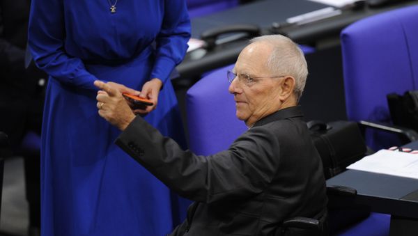German Finance Minister Wolfgang Schaeuble arrives in the hemicycle prior Germany's newly-elected parliament holds its first sitting in the Reichstag building housing the Bundestag (lower house of parliament) in Berlin on October 24, 2017 German Finance Minister Wolfgang Schaeuble arrives in the hemicycle prior Germany's newly-elected parliament holds its first sitting in the Reichstag building housing the Bundestag (lower house of parliament) in Berlin on October 24, 2017 - Sputnik International