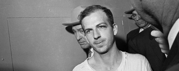 In this Nov. 23, 1963 file photo, Lee Harvey Oswald is led down a corridor of the Dallas police station for another round of questioning in connection with the assassination of US, President John F. Kennedy. Oswald, who denied any involvement in the shooting, was formally charged with murder. In this Nov. 23, 1963 file photo, Lee Harvey Oswald is led down a corridor of the Dallas police station for another round of questioning in connection with the assassination of US, President John F. Kennedy. Oswald, who denied any involvement in the shooting, was formally charged with murder. - Sputnik International