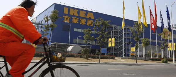 A public worker rides a bicycle in front of an Ikea shop Wednesday March 6, 2013 in Shanghai, China. Chinese authorities say they have destroyed nearly two tons of chocolate cake imported by Sweden's Ikea for violating food quality standards. - Sputnik International