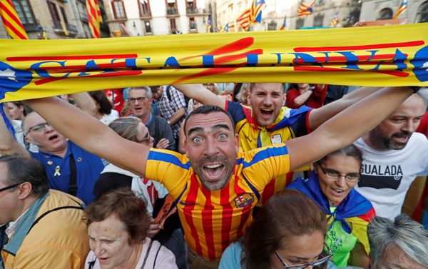 A man displays a scarf featuring an Estelada (Catalan separatist flag) design, as he reacts at Sant Jaume Square after the Catalan regional parliament declares independence from Spain in Barcelona, Spain October 27, 2017. A man displays a scarf featuring an Estelada (Catalan separatist flag) design, as he reacts at Sant Jaume Square after the Catalan regional parliament declares independence from Spain in Barcelona, Spain October 27, 2017. - Sputnik International