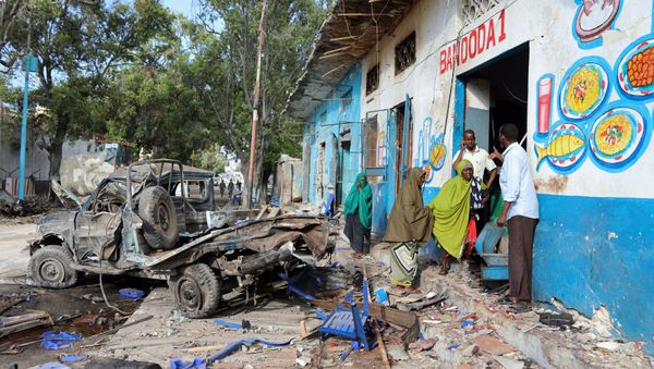 Residents gather at the scene of a suicide car bomb explosion, at the gate of Naso Hablod Two Hotel in Hamarweyne district of Mogadishu, Somalia October 29, 2017 Residents gather at the scene of a suicide car bomb explosion, at the gate of Naso Hablod Two Hotel in Hamarweyne district of Mogadishu, Somalia October 29, 2017 - Sputnik International