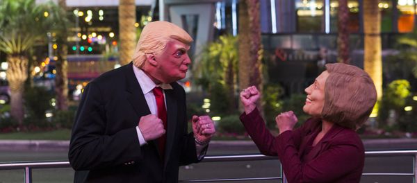 Donald Trump impersonator Rafael Almodovar, left, and Hillary Clinton impersonator Corina Almodovar entertain a crowd as early election results come in from a television display above, Tuesday, Nov. 8, 2016, during election night in Las Vegas Donald Trump impersonator Rafael Almodovar, left, and Hillary Clinton impersonator Corina Almodovar entertain a crowd as early election results come in from a television display above, Tuesday, Nov. 8, 2016, during election night in Las Vegas - Sputnik International