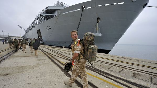 A British soldier looks back while walking to the HMS Albion warship of the British Royal Navy at anchor at port of Santander northern Spain, Tuesday, April 20, 2010. - Sputnik International