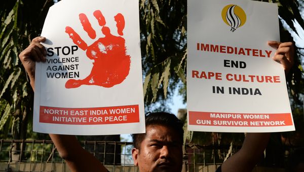 An Indian social activist hold placards during a protest against a rape at Hauz Khas village in New Delhi on February 21, 2017 An Indian social activist hold placards during a protest against a rape at Hauz Khas village in New Delhi on February 21, 2017 - Sputnik International