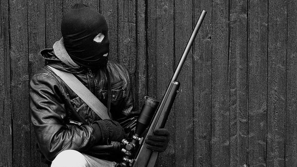 A man wearing a balaclava and holding a weapon - Sputnik International