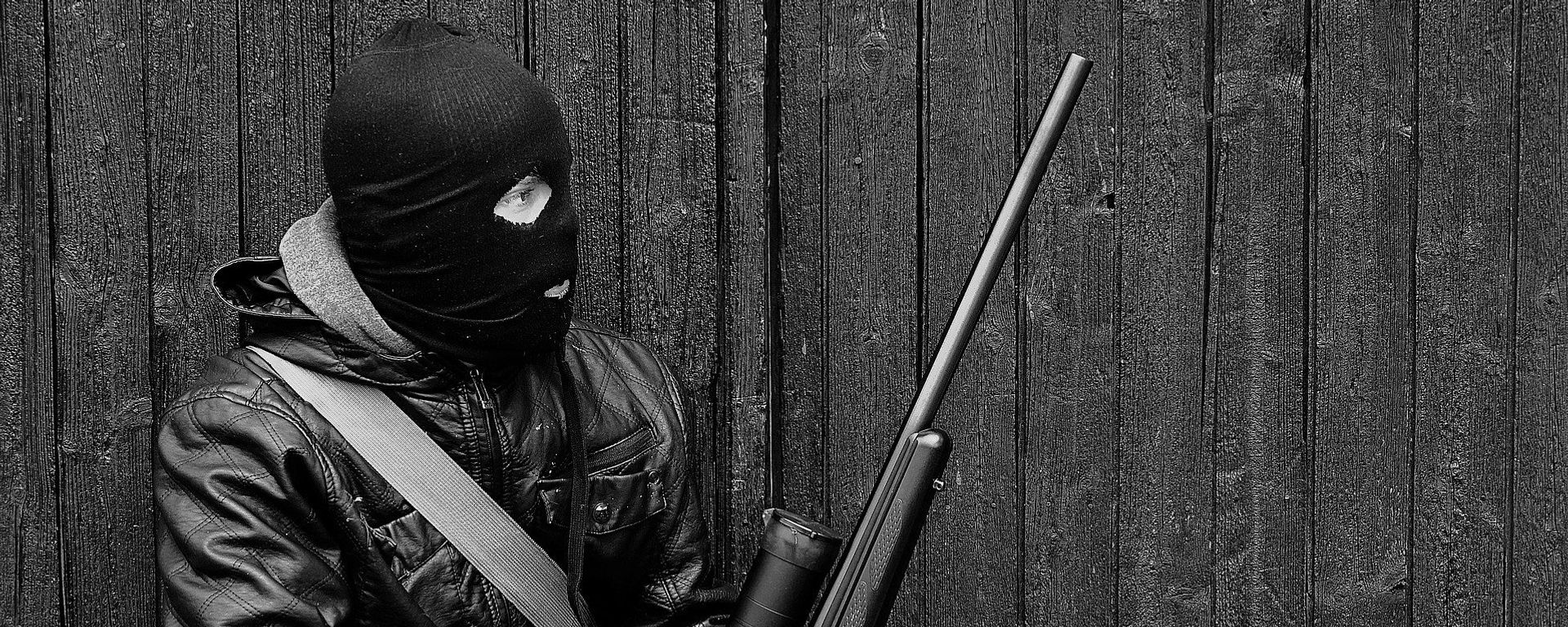 A man wearing a balaclava and holding a weapon A man wearing a balaclava and holding a weapon - Sputnik International, 1920, 07.09.2021