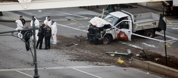 Authorities stand near a damaged Home Depot truck after a motorist drove onto a bike path near the World Trade Center memorial, striking and killing several people Tuesday, Oct. 31, 2017, in New York Authorities stand near a damaged Home Depot truck after a motorist drove onto a bike path near the World Trade Center memorial, striking and killing several people Tuesday, Oct. 31, 2017, in New York - Sputnik International