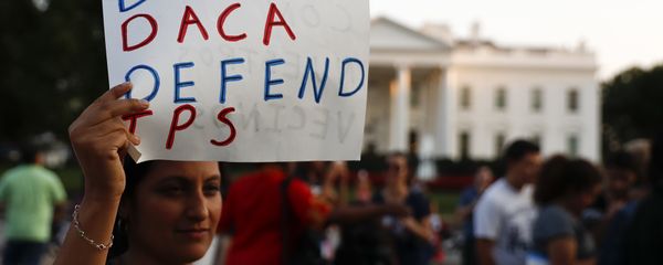 A woman holds up a sign that reads Defend DACA Defend TPS during a rally supporting Deferred Action for Childhood Arrivals, or DACA, outside the White House in Washington, Monday, Sept. 4, 2017 - Sputnik International