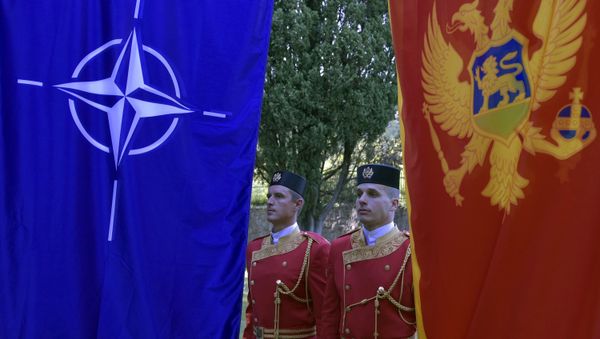 Montenegrin guards of honor stand between NATO, left, and Montenegro flags during ceremony to mark Montenegro's accession to NATO, in Podgorica, Montenegro, Wednesday, June 7, 2017 - Sputnik International