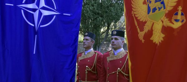Montenegrin guards of honor stand between NATO, left, and Montenegro flags during ceremony to mark Montenegro's accession to NATO, in Podgorica, Montenegro, Wednesday, June 7, 2017 Montenegrin guards of honor stand between NATO, left, and Montenegro flags during ceremony to mark Montenegro's accession to NATO, in Podgorica, Montenegro, Wednesday, June 7, 2017 - Sputnik International