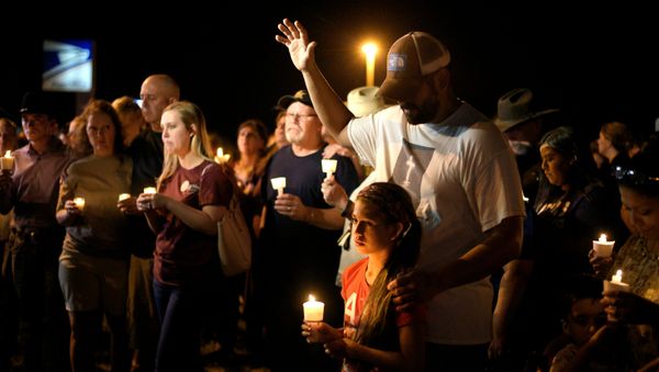Ramiro and Sofia Martinez attend a candle light vigil after a mass shooting at the First Baptist Church in Sutherland Springs, Texas, U.S., November 5, 2017 - Sputnik International