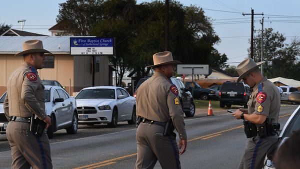 State troopers patrol at the entrance to the First Baptist Church (back) after a mass shooting that killed 26 people in Sutherland Springs, Texas on November 6, 2017 State troopers patrol at the entrance to the First Baptist Church (back) after a mass shooting that killed 26 people in Sutherland Springs, Texas on November 6, 2017 - Sputnik International