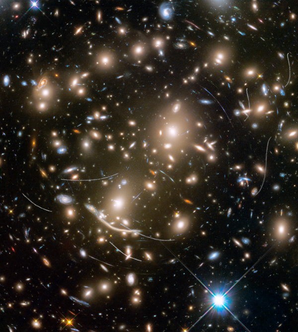 Galaxy cluster Abell 370 contains several hundred galaxies tied together by the mutual pull of gravity. It is located approximately 4 billion light-years away in the constellation Cetus, the Sea Monster. The thin, white trails that look like curved or S-shaped streaks are from asteroids that reside, on average, only about 160 million miles from Earth. Galaxy cluster Abell 370 contains several hundred galaxies tied together by the mutual pull of gravity. It is located approximately 4 billion light-years away in the constellation Cetus, the Sea Monster. The thin, white trails that look like curved or S-shaped streaks are from asteroids that reside, on average, only about 160 million miles from Earth. - Sputnik International
