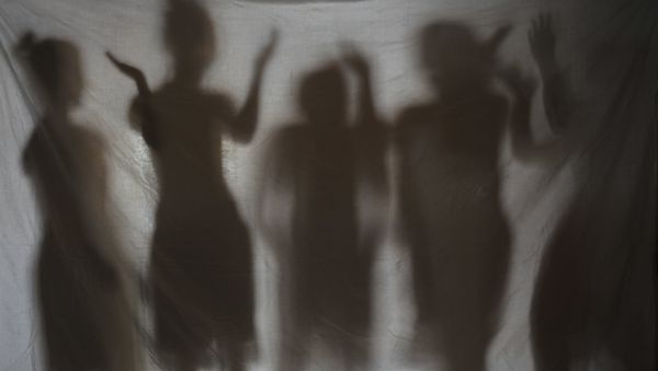The shadows of five teenage girls rescued from a cyber sex den is seen in this photo taken at Preda Foundation office on December 2, 2010 in Olongapo City - Sputnik International