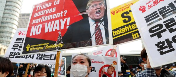 Protesters against U.S. President Donald Trump hold placards while waiting for Trump's motorcade to pass by in central Seoul, South Korea, November 7, 2017 - Sputnik International