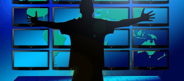 A silhouette of a man in front of multiple screens - Sputnik International