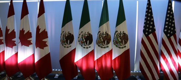 National flags representing Canada, Mexico, and the US are lit by stage lights at the North American Free Trade Agreement, NAFTA, renegotiations, in Mexico City, Tuesday, Sept. 5, 2017. National flags representing Canada, Mexico, and the US are lit by stage lights at the North American Free Trade Agreement, NAFTA, renegotiations, in Mexico City, Tuesday, Sept. 5, 2017. - Sputnik International