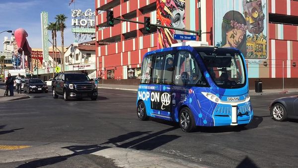A driverless shuttle bus rolls down a street in Las Vegas A driverless shuttle bus rolls down a street in Las Vegas - Sputnik International