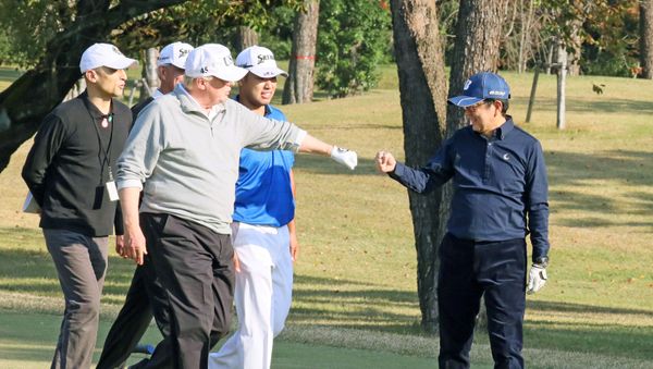 U.S. President Donald Trump gestures to Japan's Prime Minister Shinzo Abe as Japanese professional golfer Hideki Matsuyama looks on, as they play golf at the Kasumigaseki Country Club in Kawagoe, north of Tokyo, Japan, in this photo taken and released by Japan's Cabinet Public Relations Office via Kyodo November 5, 2017 U.S. President Donald Trump gestures to Japan's Prime Minister Shinzo Abe as Japanese professional golfer Hideki Matsuyama looks on, as they play golf at the Kasumigaseki Country Club in Kawagoe, north of Tokyo, Japan, in this photo taken and released by Japan's Cabinet Public Relations Office via Kyodo November 5, 2017 - Sputnik International