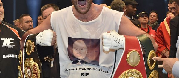 In this Nov. 29, 2015 file photo, Britain's new world champion Tyson Fury, celebrates with the WBA, IBF, WBO and IBO belts after winning the world heavyweight title fight against Ukraine's Wladimir Klitschko in Duesseldorf, western Germany. - Sputnik International
