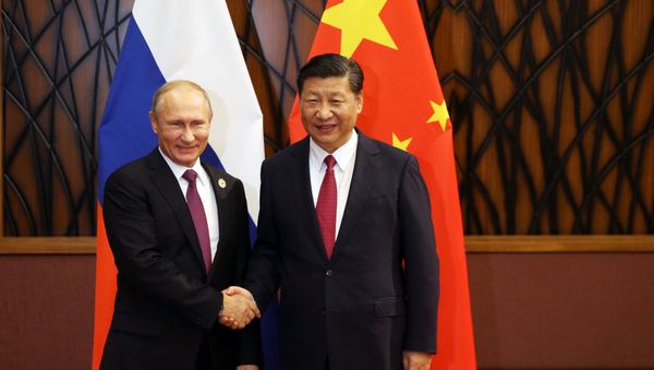Russian President Vladimir Putin and Chinese President Xi Jinping shake hands during a meeting on the sidelines of the APEC summit in Danang, Vietnam Russian President Vladimir Putin and Chinese President Xi Jinping shake hands during a meeting on the sidelines of the APEC summit in Danang, Vietnam - Sputnik International