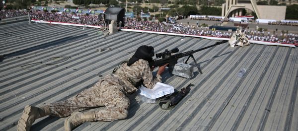 A Houthi Shiite sniper keeps watch over a rally to mark the third anniversary of the Houthis' takeover of the Yemeni capital, in Sanaa. - Sputnik International