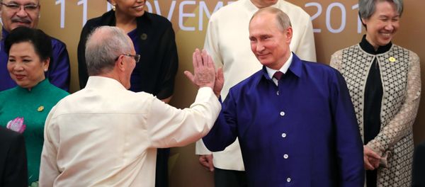 Russian President Vladimir Putin poses for a family photo in traditional Vietnamese clothes during the APEC Economic Leaders’ Meeting in Vietnam Russian President Vladimir Putin poses for a family photo in traditional Vietnamese clothes during the APEC Economic Leaders’ Meeting in Vietnam - Sputnik International