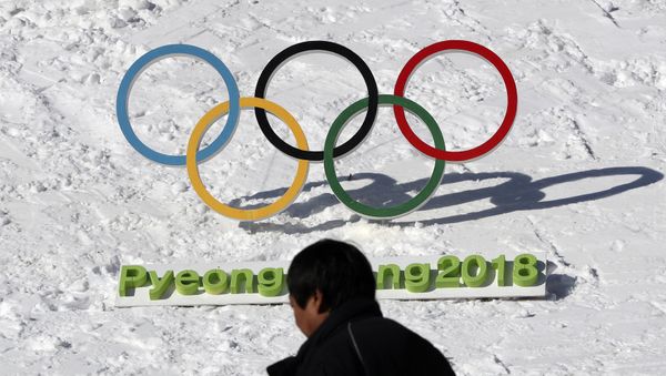 In this Feb. 3, 2017 photo, a man walks by the Olympic rings with a sign of 2018 Pyeongchang Olympic and Paralympic Winter Games in Pyeongchang, South Korea - Sputnik International