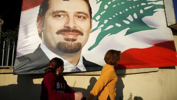 A woman and her daughter pass by a poster of outgoing Prime Minister Saad Hariri, in Beirut, Lebanon, Saturday, Nov. 11, 2017. Lebanon's president has called on Saudi Arabia to clarify the reasons why the country's prime minister has not returned home since his resignation which was announced from the kingdom A woman and her daughter pass by a poster of outgoing Prime Minister Saad Hariri, in Beirut, Lebanon, Saturday, Nov. 11, 2017. Lebanon's president has called on Saudi Arabia to clarify the reasons why the country's prime minister has not returned home since his resignation which was announced from the kingdom - Sputnik International