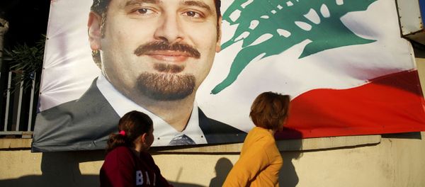 A woman and her daughter pass by a poster of outgoing Prime Minister Saad Hariri, in Beirut, Lebanon, Saturday, Nov. 11, 2017. Lebanon's president has called on Saudi Arabia to clarify the reasons why the country's prime minister has not returned home since his resignation which was announced from the kingdom - Sputnik International