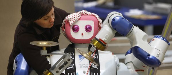 Annette Vorreiter decorates a dual arm robot maid by Japan's Yaskawa Electric company during preparation of the Hanover industrial fair in Hanover, Germany, Friday, April 18, 2008 Annette Vorreiter decorates a dual arm robot maid by Japan's Yaskawa Electric company during preparation of the Hanover industrial fair in Hanover, Germany, Friday, April 18, 2008 - Sputnik International