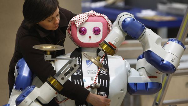 Annette Vorreiter decorates a dual arm robot maid by Japan's Yaskawa Electric company during preparation of the Hanover industrial fair in Hanover, Germany, Friday, April 18, 2008 Annette Vorreiter decorates a dual arm robot maid by Japan's Yaskawa Electric company during preparation of the Hanover industrial fair in Hanover, Germany, Friday, April 18, 2008 - Sputnik International